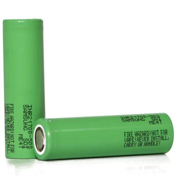 Two green Samsung INR21700-50S batteries with fire hazard warning text.